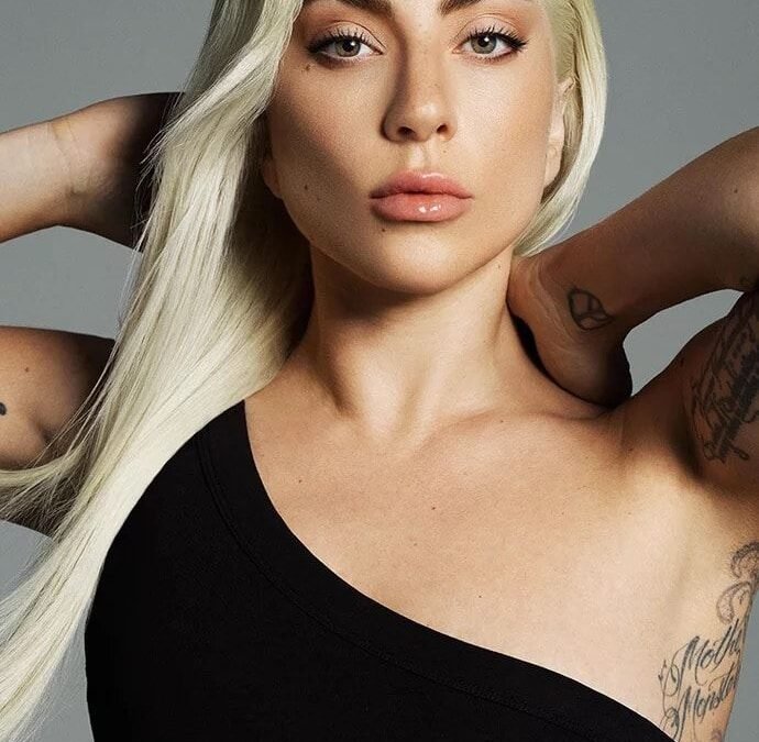 Lady Gaga in black dress with blond hair